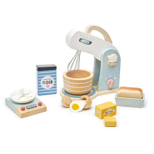 Wooden Home Baking Toy by Tender Leaf Toys, featuring a stand mixer with metal whisk, kitchen scales, eggs, butter, and flour for role play baking.