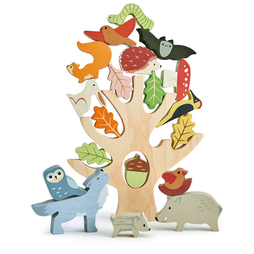 Wooden Stacking Forest Toy by Tender Leaf Toys, showing 21 colourful animal and plant pieces balanced on a tree trunk.