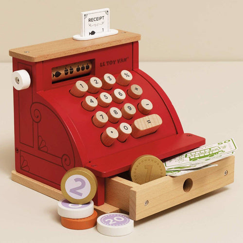 Wooden, retro style cash register toy by Le Toy Van with a red and dark finish, easy-open drawer, and wooden and paper play money.