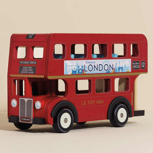 Multi-award winning wooden double decker London bus toy painted bright red with opening roof and detailed seating.