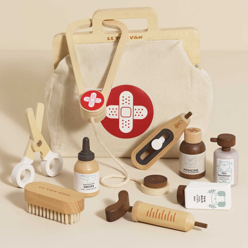 Wooden Animal Care Set by Le Toy Van, featuring a vintage style medical bag and 10 wooden accessories including a stethoscope, syringe, and paw balm.