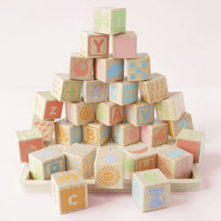 30 colourful wooden alphabet blocks by Le Toy Van, featuring letters, numbers, and animal illustrations, neatly stored in a wooden tray.