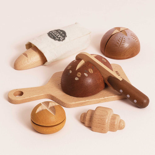 Wooden Artisan Bread Set by Le Toy Van, including five types of bread, a cutting board, a knife, and a cotton baguette bag for kitchen role play.