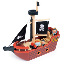 Wooden toy pirate boat by Mentari with fabric sails, ship's wheel, cannon, and three wooden pirate characters.