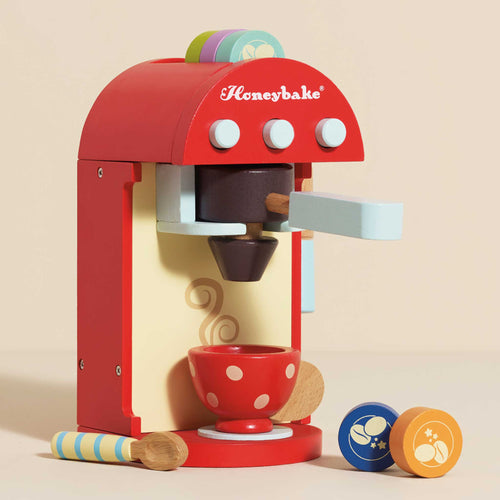 Award-winning wooden coffee machine toy by Le Toy Van with a milk frother, removable portafilter, wooden pods, cup, and spoon.