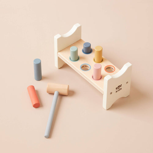 Wooden hammer bench toy by Just Bee Kids with soft rainbow coloured pegs and an easy grip beater for developing hand-eye coordination.